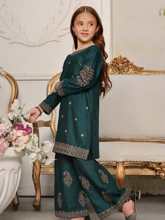 A girl wearing a green embroidered lawn stitched 2 piece dress with floral patterns.